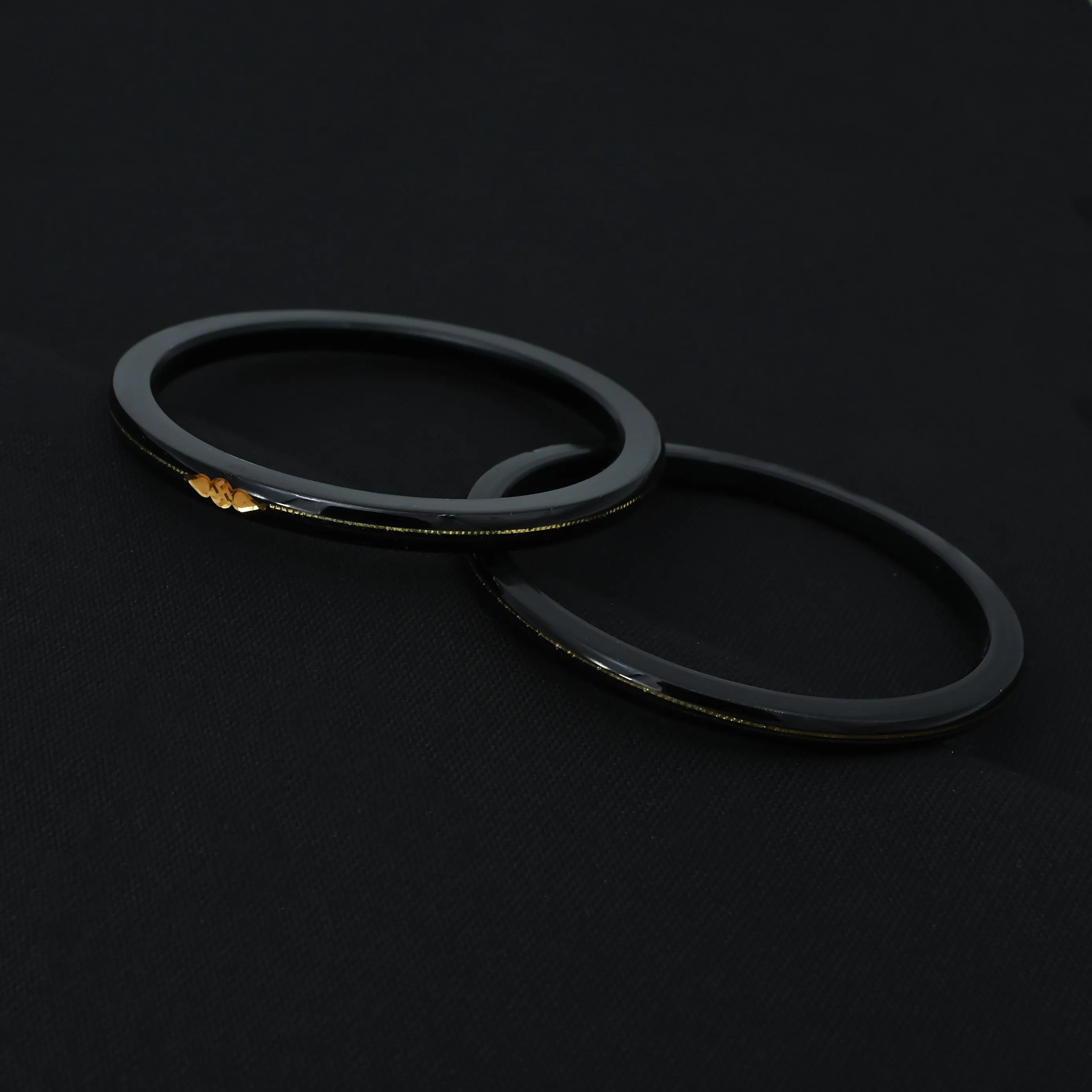 Silver Center Swathik Design Black Bangles